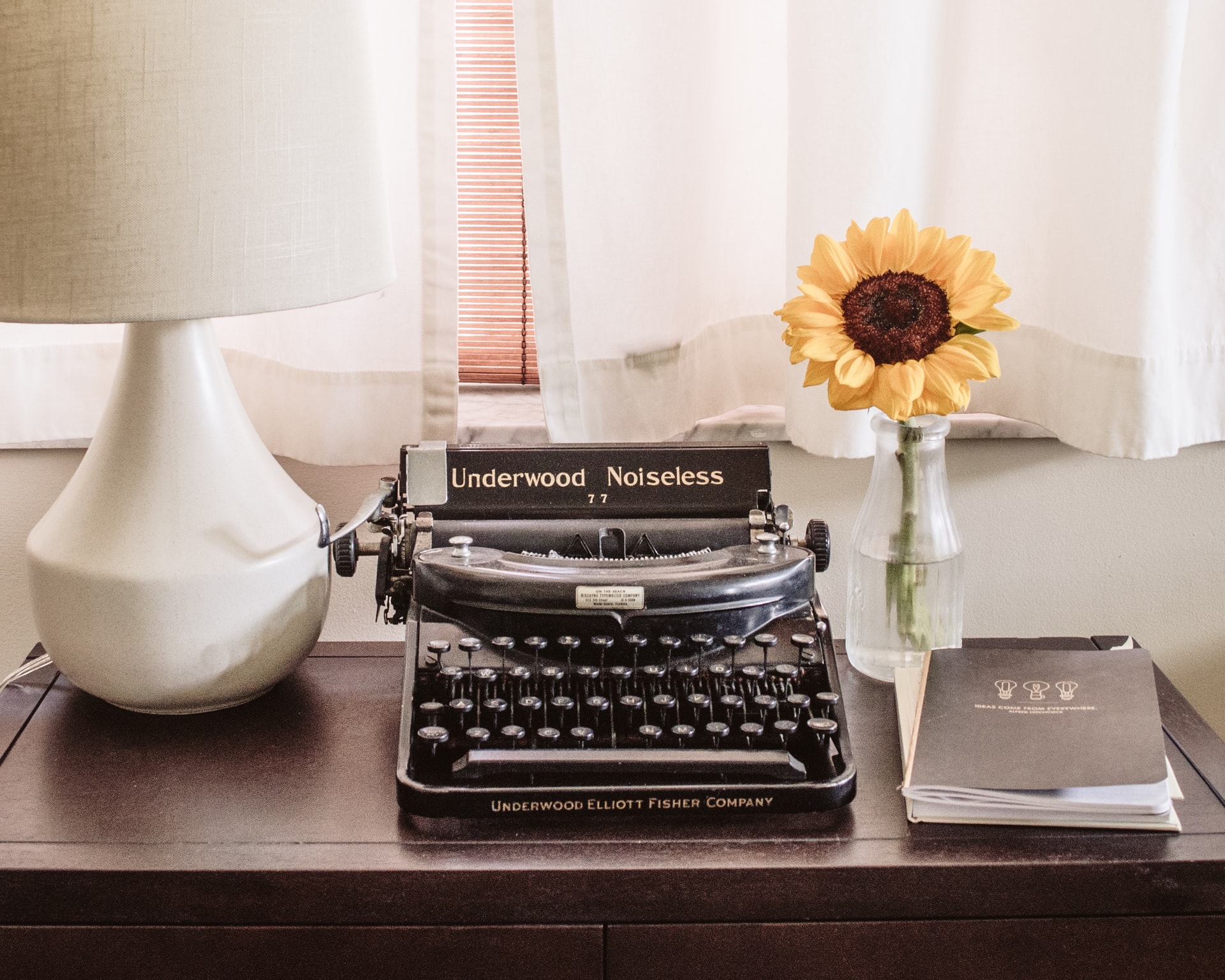 Picture of a typewriter and sunflower as used by an editor
